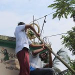 Two volunteers fixing a freedombox antenna